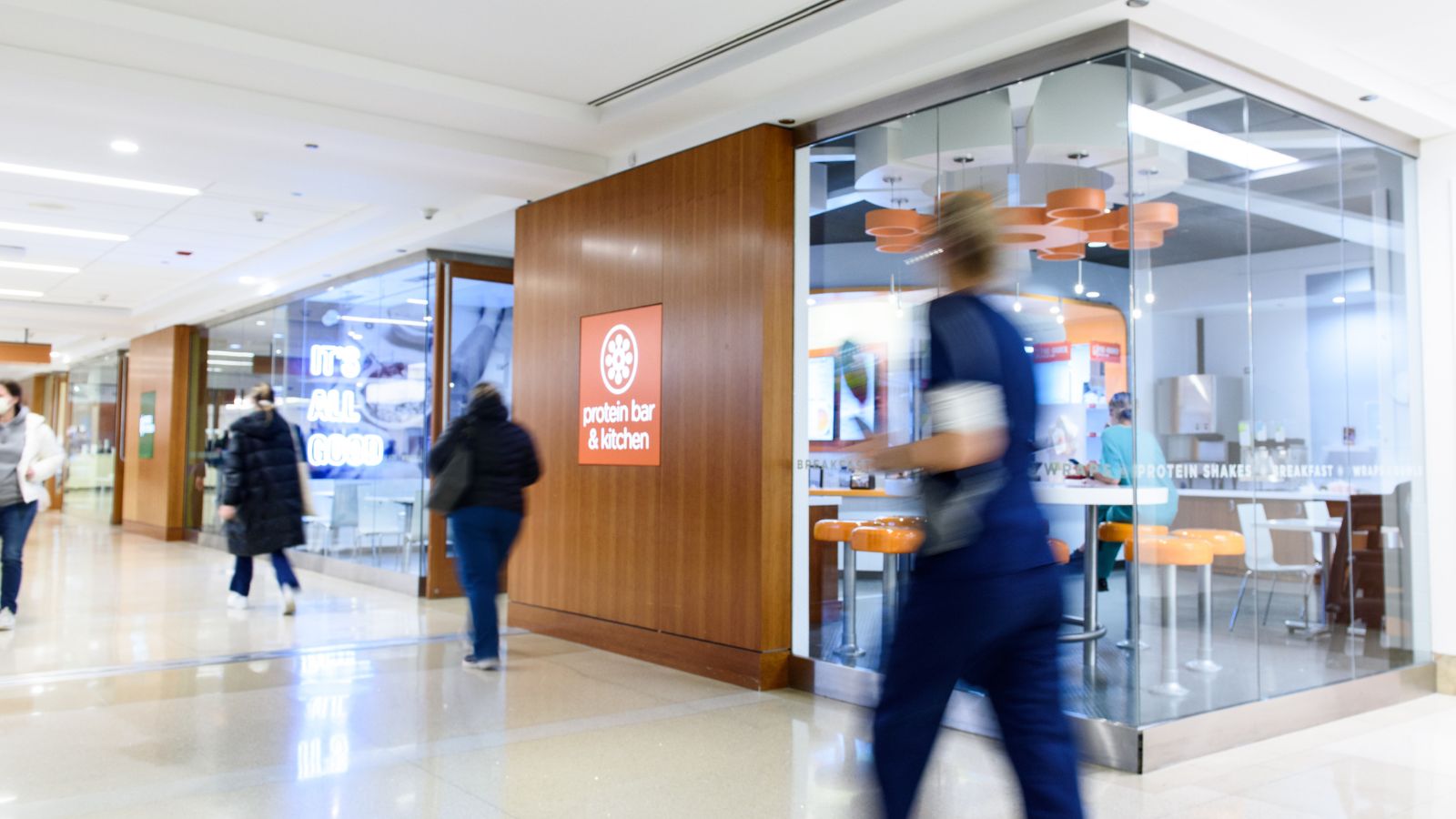 Protein Bar & Kitchen glass storefront with seating inside Northwestern Memorial Hospital