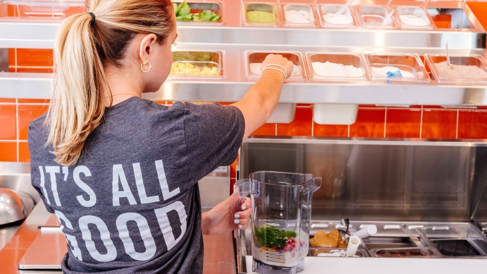 Protein Bar & Kitchen team member building a smoothie at the prep line
